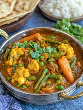 Delicious Navratan Korma or Vegetable Curry with Naan Bread and Rice in a Silver Bowl Close Up