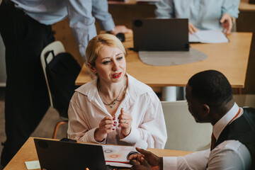 Colleagues engaging in a discussion while working at a modern co working office.