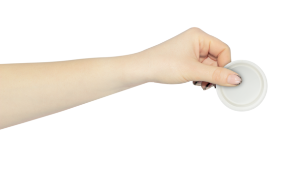 wide cap from a plastic bottle in hand, outstretched hand with cap from a plastic bottle isolated from background	