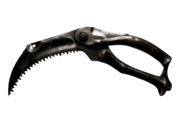 Unique curved harvesting tool with a metal grip and serrated edge