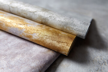 Metallic textured wallpaper rolls in gold and silver tones, featuring sophisticated mineral patterns and luxurious, modern finish, perfect for elegant interior decoration
