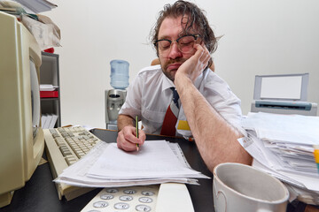 Exhausted office worker falls asleep over documents at messy desk, showing burnout, boredom and mental fatigue in everyday corporate routine. Concept of business, retro office, emotions