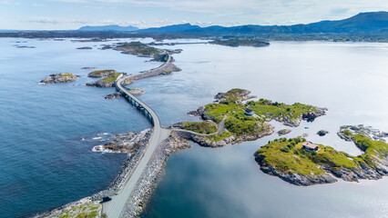 A captivating view of a winding coastal road connecting picturesque islets in Norway. The serene waters and lush greenery create a tranquil atmosphere, Atlantic Ocean Road, Norway