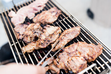 Raw pork on the barbecue over the coals. Preparing a Delicious BBQ
