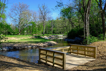 Observation deck overlooking streambank and floodplain restoration on a small stream. It stabilizes and alters the stream channel to slow and direct the flow of water to reduce erosion and flooding.