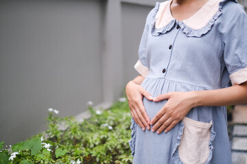 pregnant asian woman in the garden