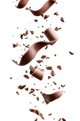 Chocolate curls and shavings falling on white background studio shot overhead view food photography dessert ingredient baking
