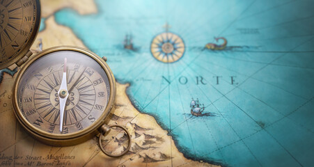 Old compass on world map.Travel, geography, navigation, tourism and exploration concept wide background. Macro photo. Very shallow focus.