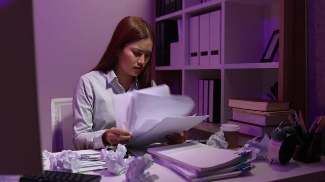 a businesswoman works late into the night because she has to deal with important contract documents that ned to be presented tomorrow, one of the employees worked overtime