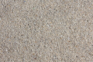 Captivating texture of fine sand under bright sunlight creates an inviting natural landscape