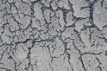 Cracked earth texture revealing intricate patterns in a dry landscape under bright sunlight
