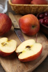 Apples and tasty cherries on wooden table, closeup