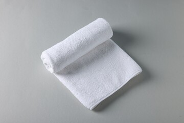 Clean towel on gray background, above view