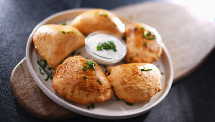 Composition with a plate of oven-baked pierogi
