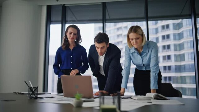 Stressed coworkers frustrated problem reading laptop email. Tensed colleagues 