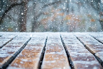 Fototapeta premium Winter snowfall covering wooden surface with fresh powder and soft blurred forest background