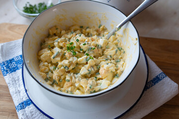 Traditional german egg salad with pickles and mayonnaise in a bowl