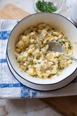 Traditional german egg salad with pickles and mayonnaise in a bowl