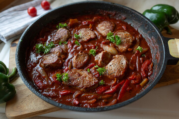 Pork fillet with spicy puszta sauce in a frying pan. Delicious homemade food
