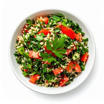 Fresh tabbouleh salad featuring chopped parsley, tomatoes, cucumbers, and bulgur wheat in a white bowl