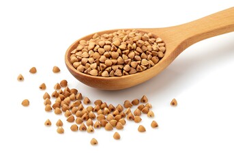 Buckwheat grains in a wooden spoon and scattered around on a white surface in a close up shot