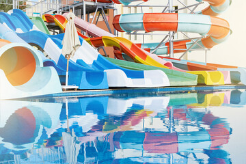 Water park with water colored flights, slides, splashes and pools at luxury hotel. summer vacation activity on holiday at outdoor waterpark or aquapark. Concept summer travel and vacation background.