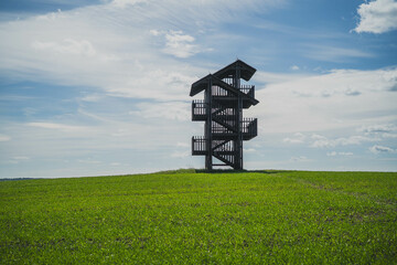 An observation tower in a Masurian field on a beautiful sunny May day.