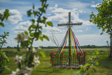 The cross in meadows and fields, which is decorated. May, Poland.