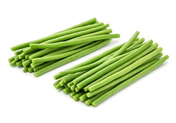 Two bunches of fresh green long beans neatly arranged on a plain white surface in a studio shot