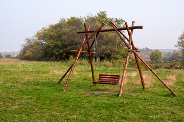  Rustic Handmade Wooden Log Swing Bench in Quiet Meadow: Peaceful Countryside Relaxation Scene and...