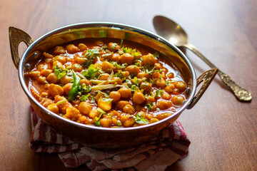 Kabuli Chana Masala is a flavorful North Indian curry made with chickpeas, tomatoes, onions, and aromatic spices, simmered to a rich, hearty consistency.

