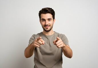 Fototapeta premium Enthusiastic man with confident expression and gesture, pointing his fingers. Focused gaze and positive body language displayed against solid backdrop.