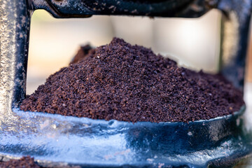 Ground coffee in the manual grinder
