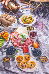 Picnic, appetizers and cheese and meat platter with sweet and savory muffins and fruits