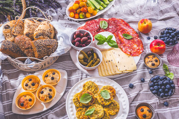 Picnic, appetizers and cheese and meat platter with sweet and savory muffins and fruits