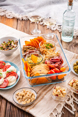 Tray with appetizers and wine for a picnic, outdoor eating