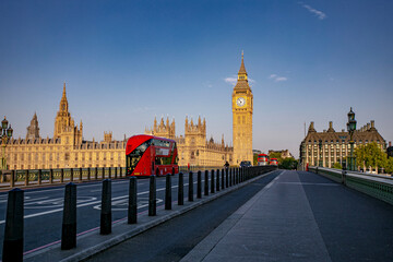 An Iconic London Landscape Showcasing Big Ben Alongside a Classic Red Bus in Action