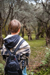 Obraz premium Boy Hiking Near Cliffs Watching Olive Trees