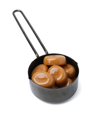 Tasty sweet caramel candies isolated on white