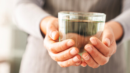 Woman holding a glass of drinking water