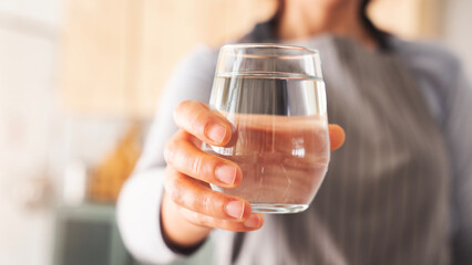 Woman holding a glass of drinking water