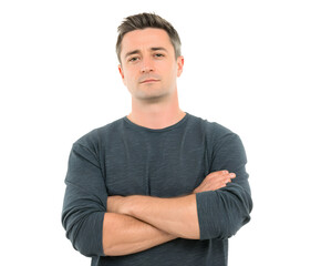 Fototapeta premium A man in a grey long-sleeve shirt stands with arms crossed, looking straight ahead.