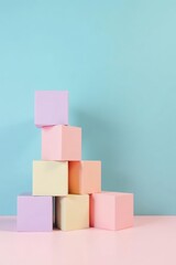 Pastel-colored cubes arranged in a visually appealing pyramid shape against a soft blue and pink background
