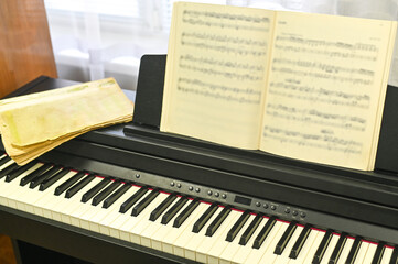 Open sheet music on modern digital piano, ready for performance and inspiration