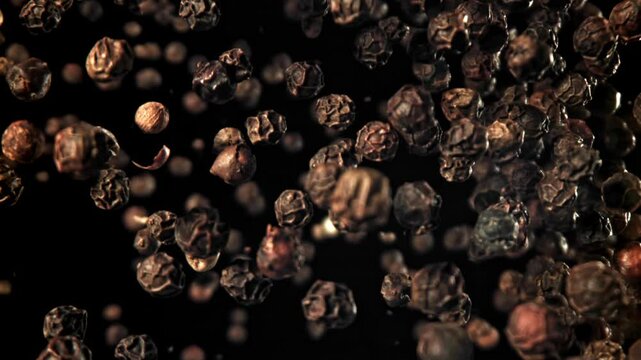 Black pepper flies up and falls down. Filmed on a high-speed camera at 1000 fps. High quality FullHD footage