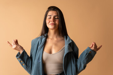 Young woman meditating with closed eyes and gyan mudra hand gesture