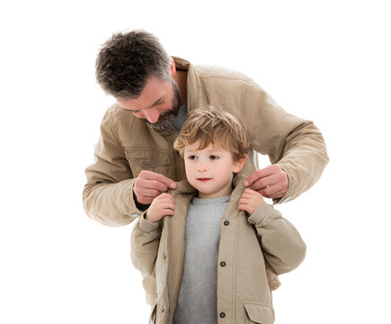 A father assists his young son by buttoning up his jacket, showing a tender moment of care and love. - Powered by Adobe