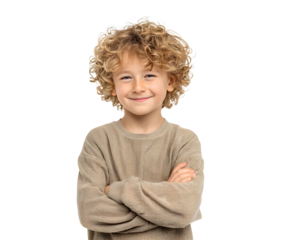 A charming young boy with curly hair smiles, arms crossed, a portrait of pure joy and happiness.