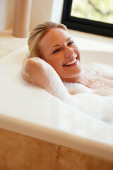 Bathroom, happy and portrait of woman in bath with soap, bubbles and foam for cleaning, washing and grooming. Relax, pamper and person in water for calm for skincare, wellness and self care in home
