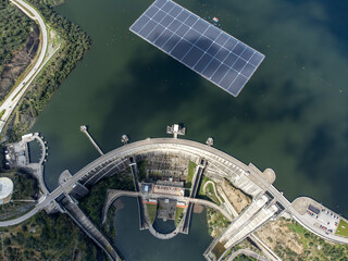 Aerial view of Alqueva Dam at full capacity, with floating solar panels on the water. Alentejo, Portugal.
